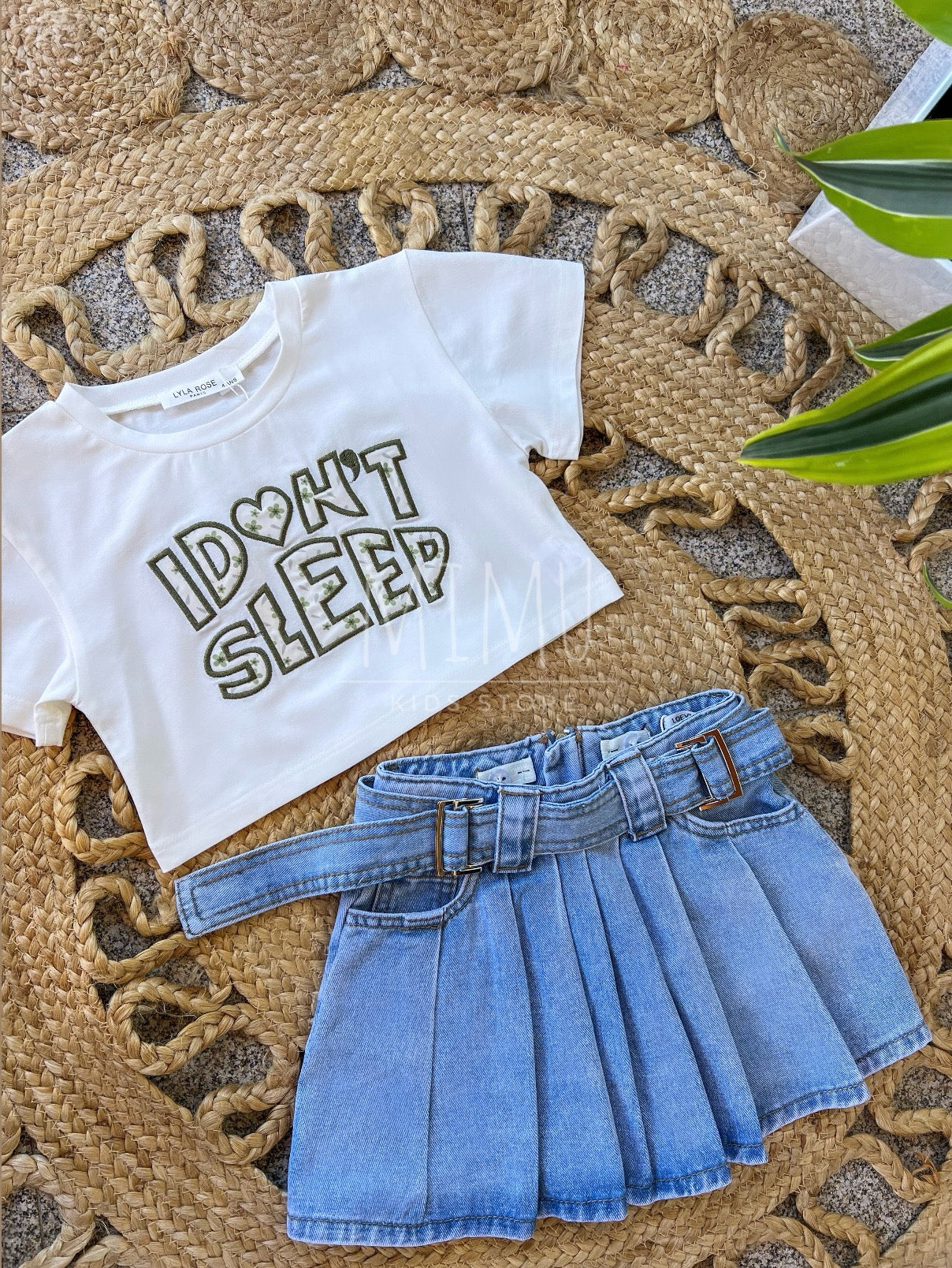 Denim skirt with pleats and Cropped “I don't sleep” T-shirt (items purchased individually)